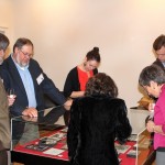 Photograph of guests examining an exhibition case at the exhibition opening of "100 Years of Jayhawks, 1912-2012"