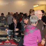 Photograph of guests Mingling in the new exhibition space at the opening of the "100 Years of Jayhawks, 1912-2012" exhibition.