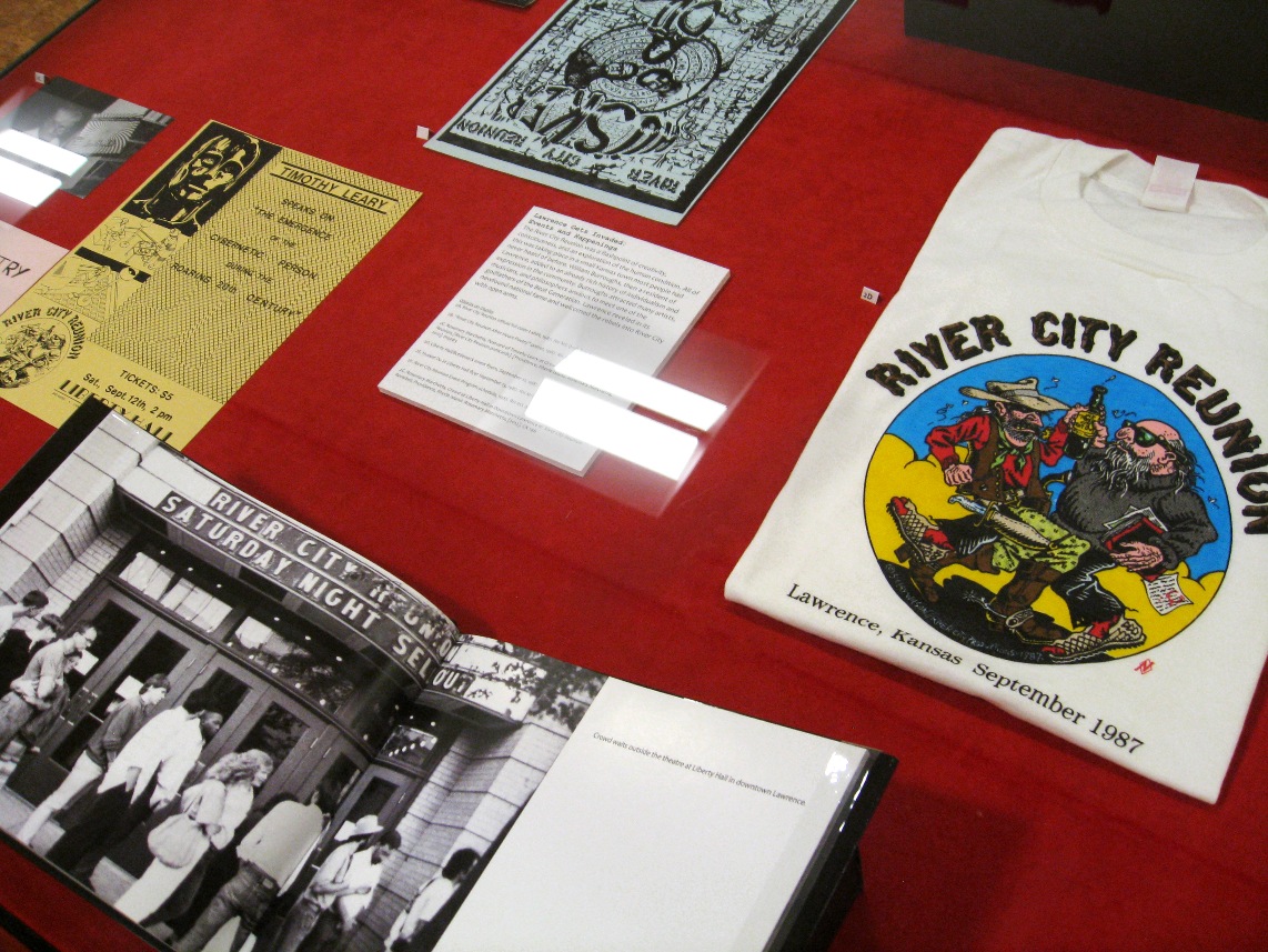 Exhibition case featuring materials from the 1987 River City Reunion in Lawrence, KS.