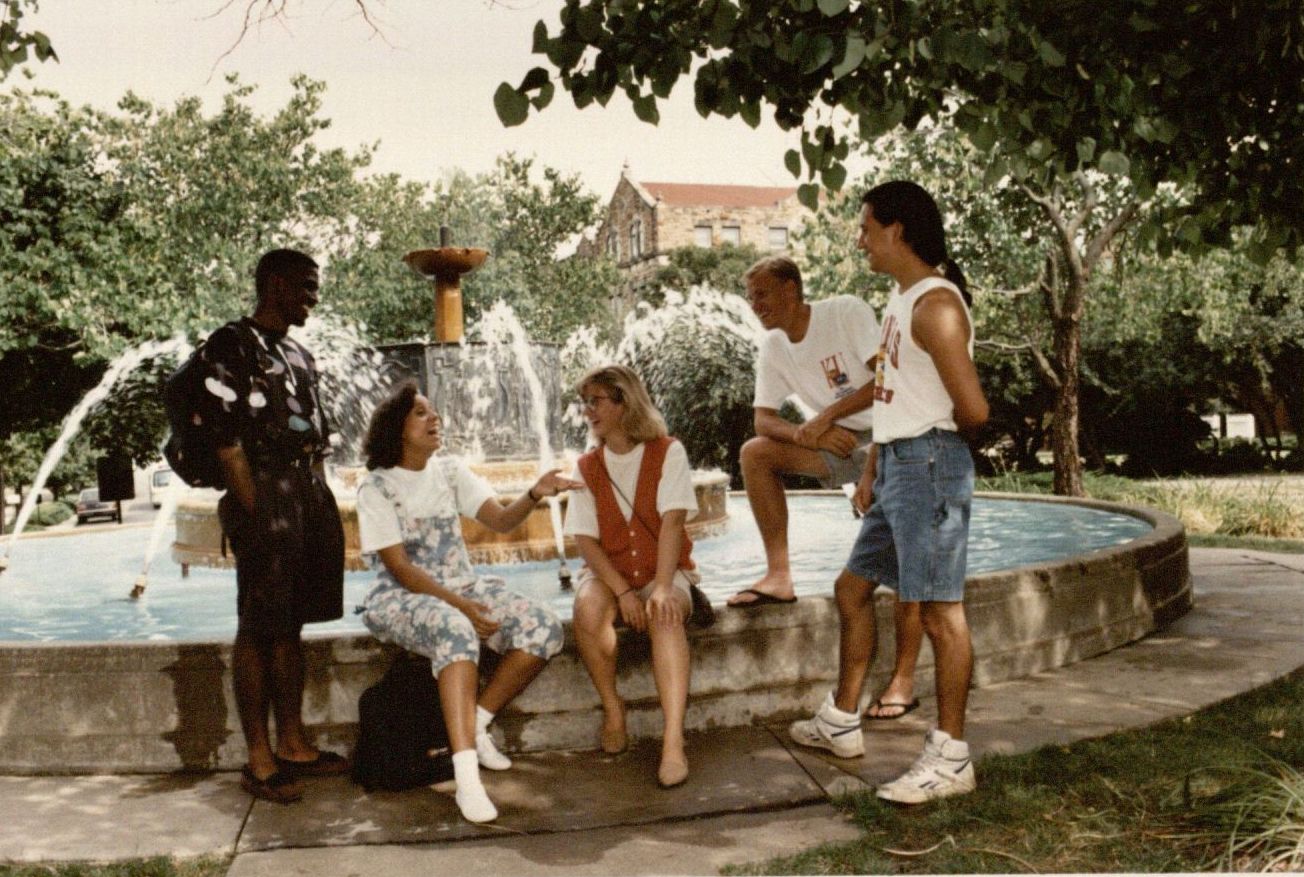 Photograph of two five students by the Chi Omega Fountain, 1991