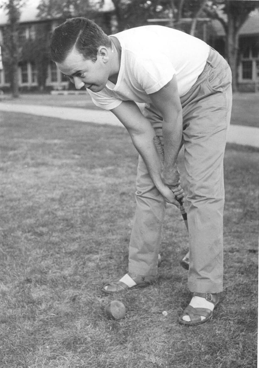 Photograph of man with croquet mallet and ball during summer session PE class, 1941
