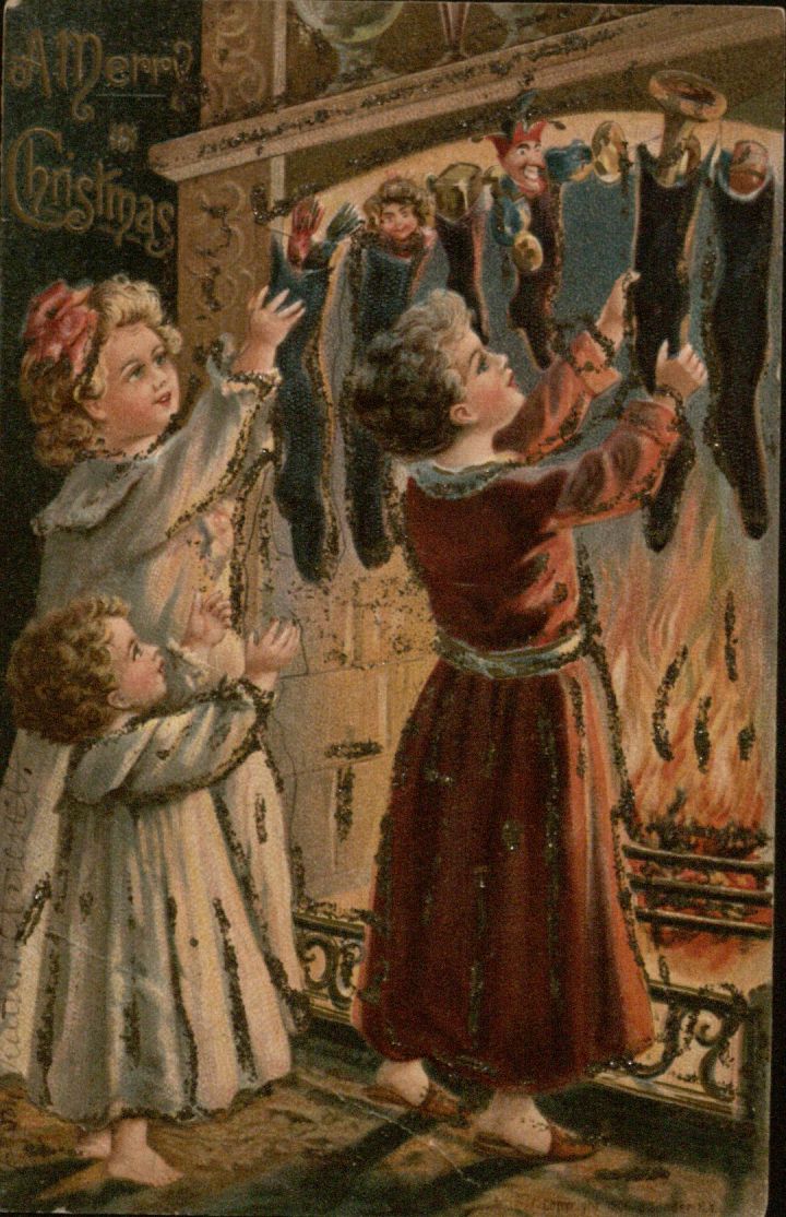 Christmas Postcard featuring children hanging stockings by the fire, ca. 1900-1910
