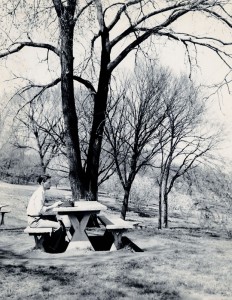 Photograph of student with typewriter outside, 1950s. 