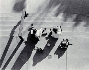 Photograph of two students studying on stairs, 1980-1981. 