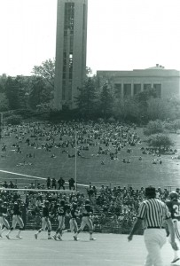 Photograph of the hill and campanile during a football game, 1975-1976