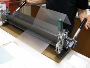 Using sheet metal bender to bend Vivak for cradle.