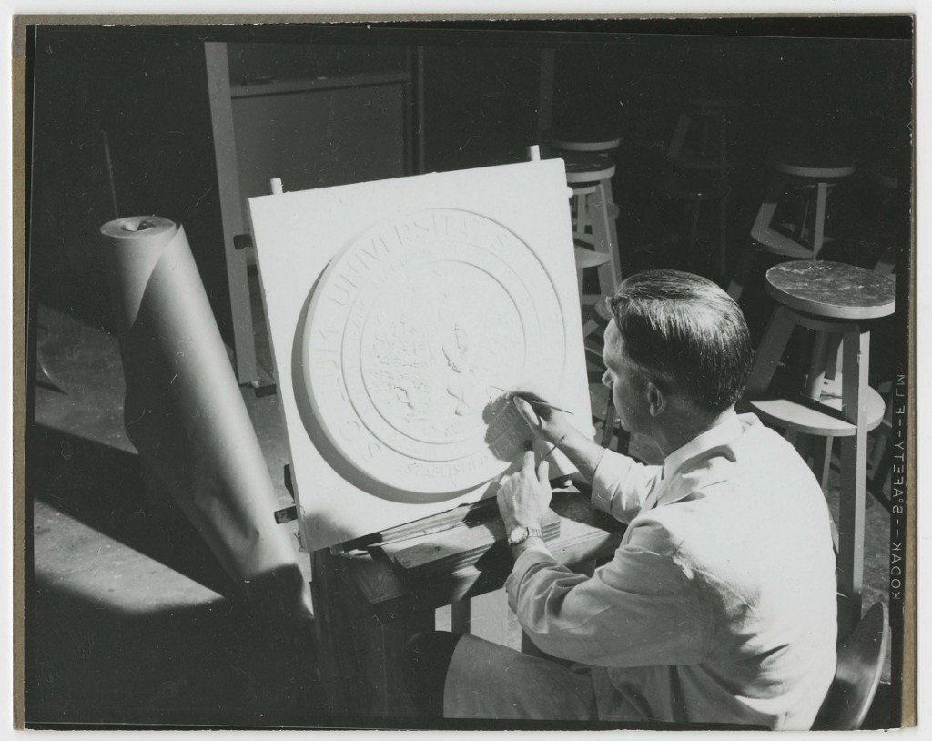 Photograph of Elden Tefft working on the university seal, 1955
