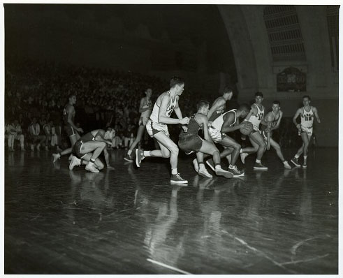 Photograph of Dean Smith in a game against Nebraska State, 1952-1953