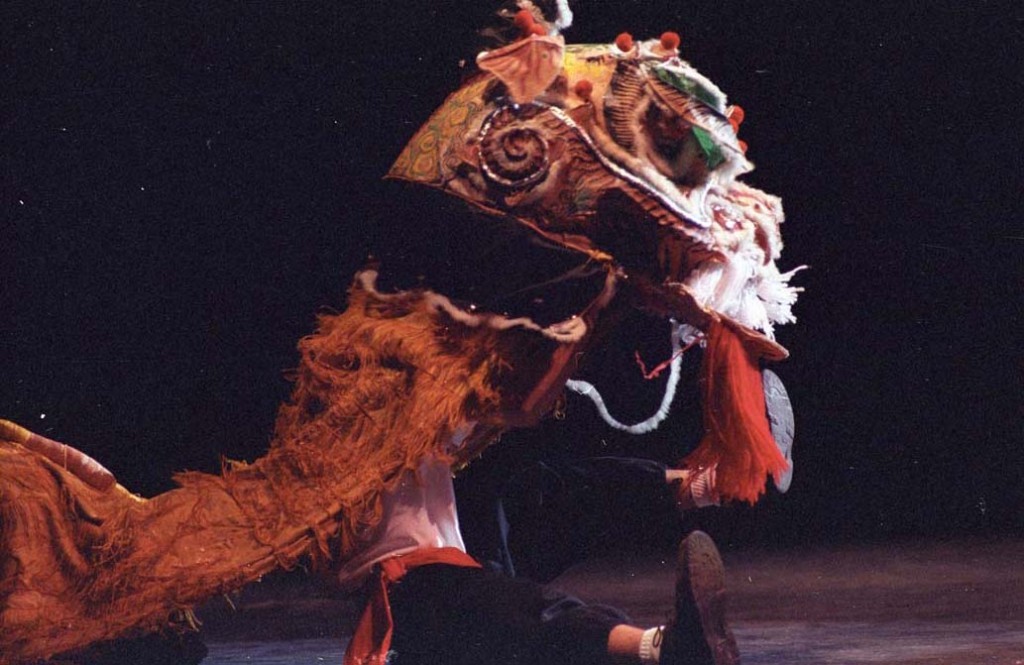 Photograph of a Chinese New Year celebration, person dancing with a dragon costume, 1994