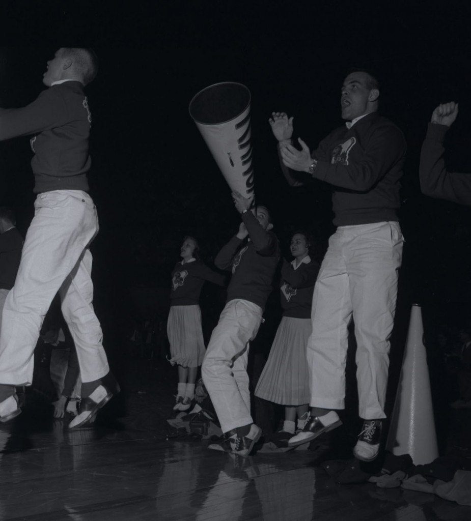 Photograph of KU cheerleaders with a megaphone, 1957