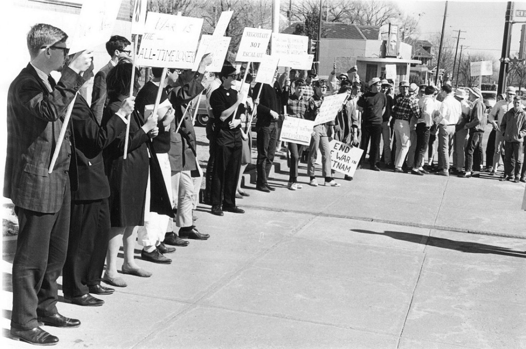 Photograph of a group of Vietnam protestors in downtown Lawrence, 1965 February 21
