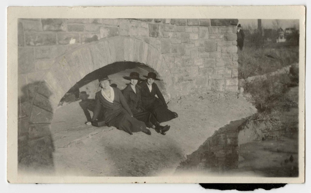 Photograph of three women sitting under Potter Bridge, 1920s
