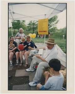 Chancellor Hemenway reading a story at Mayfest, Potter Lake, 1998