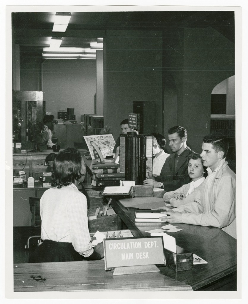 Photograph of the circulation department main desk, 1958