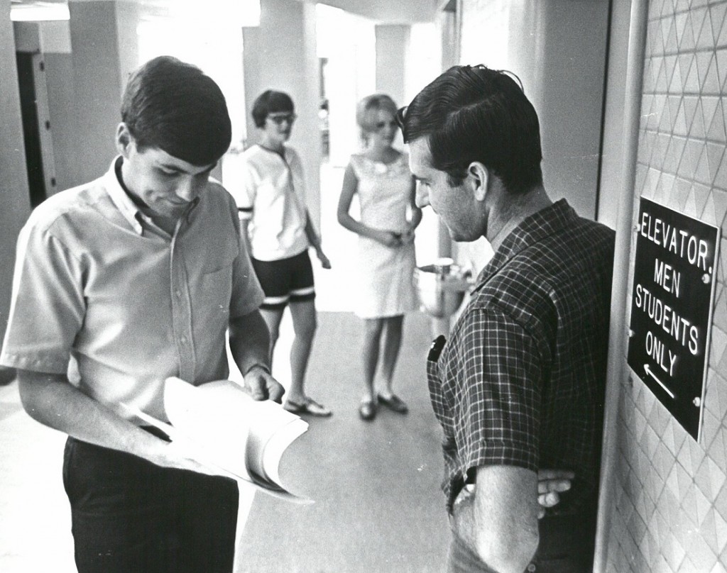 Photograph of four students at the crossroads of McCollum Hall, 1967