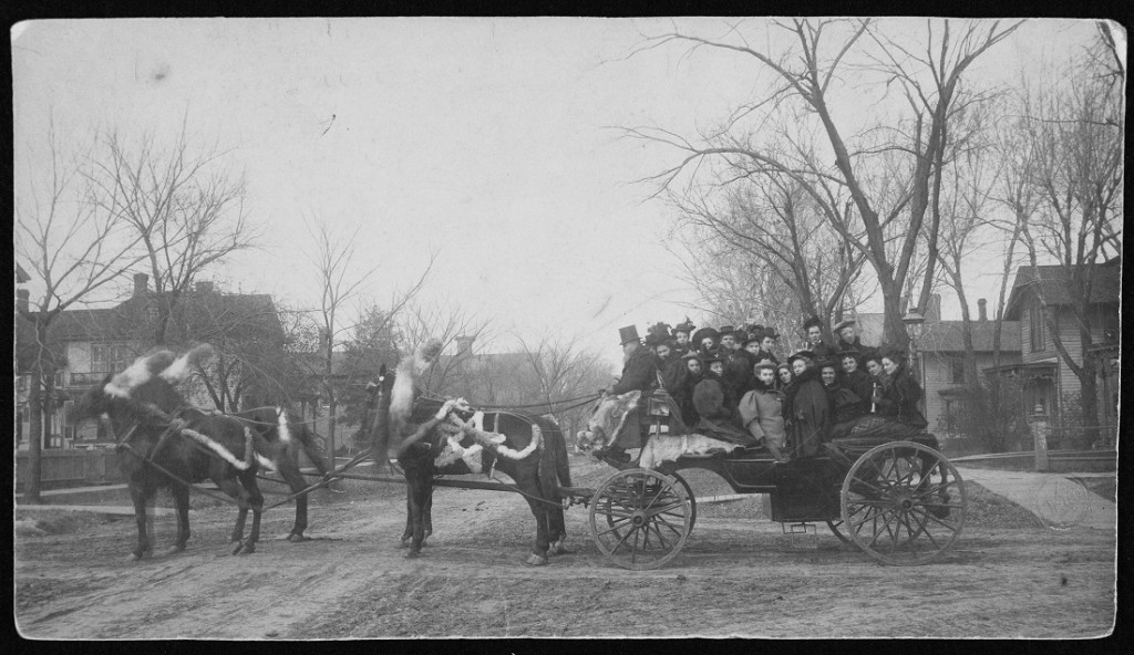 Photograph of KU fans taking a carriage to a football game, 1895