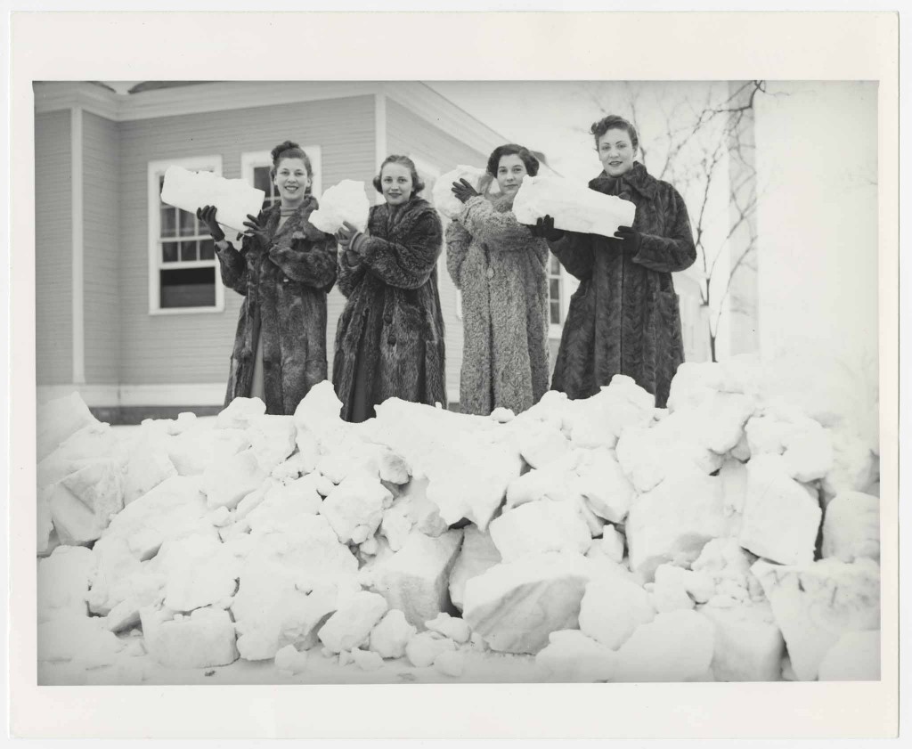 Photograph of women holding blocks of snow, 1936-1937