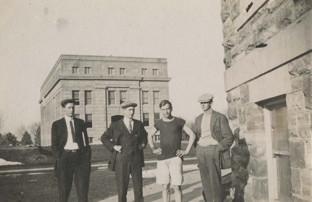 Photograph of four men in front of Strong Hall, 1911