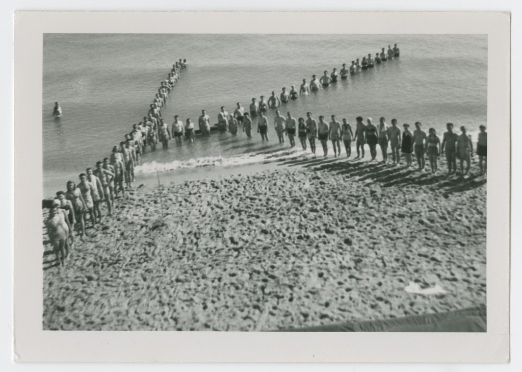 Photograph of members of the KU Marching Band at the beach, 1948