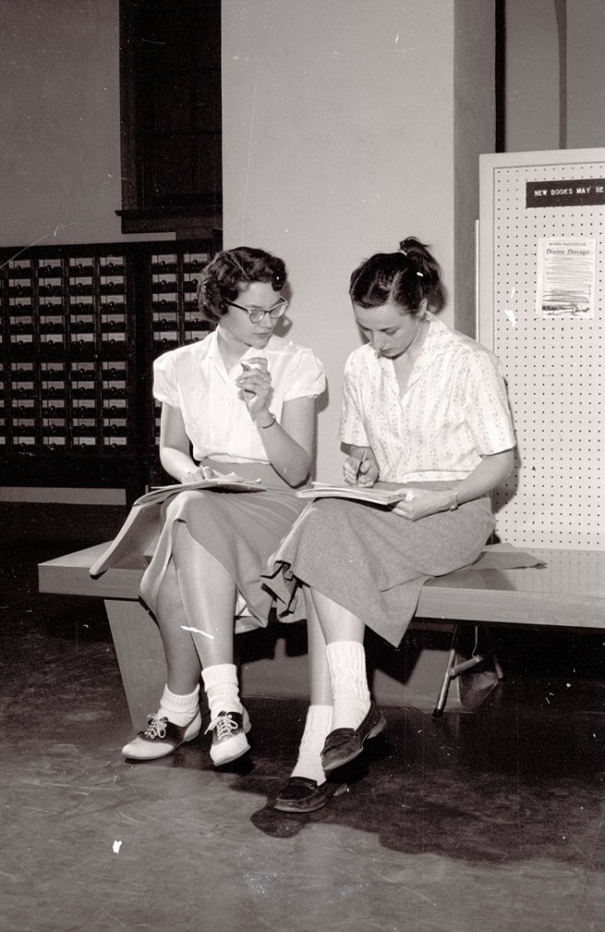 Photograph of two female students at Watson Library, 1959