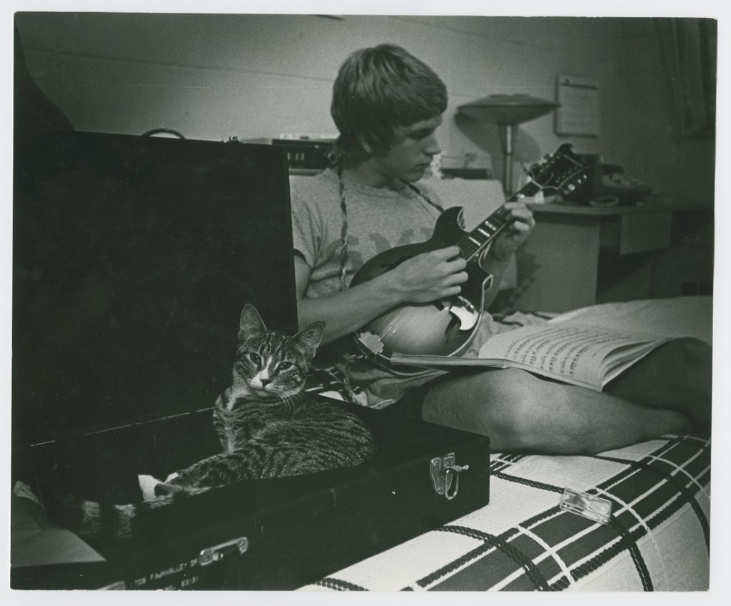 Photograph of a KU student with a cat, 1975-1976