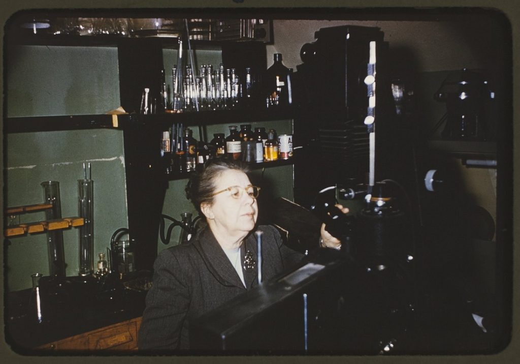 Photograph of Cora Downs in a laboratory, 1956