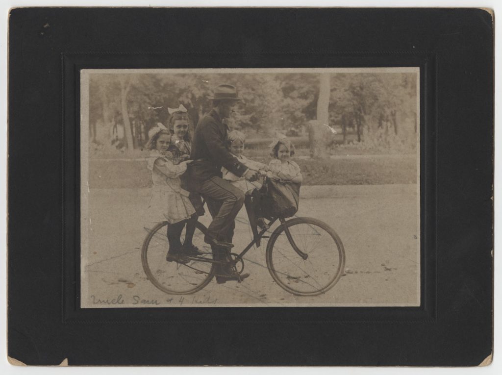 Photograph of Samuel Elliott with his children on a bicycle, circa 1904
