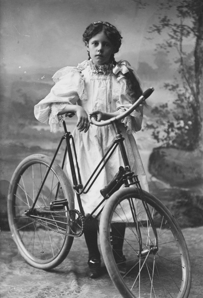 Photograph of Mattie Parrish with a bicycle, 1897
