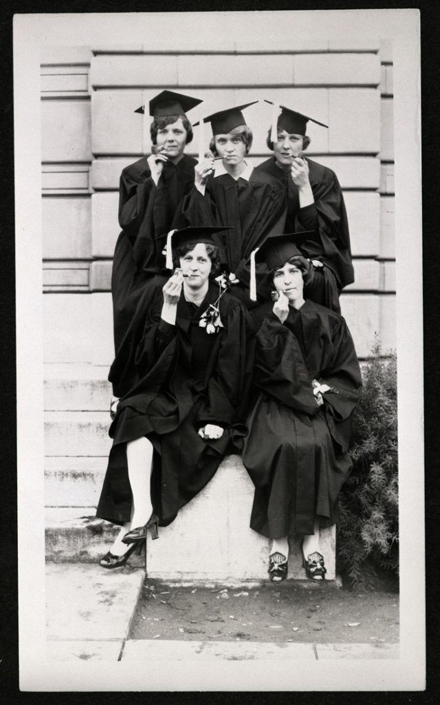 Photograph with four KU graduates with pipes, 1928