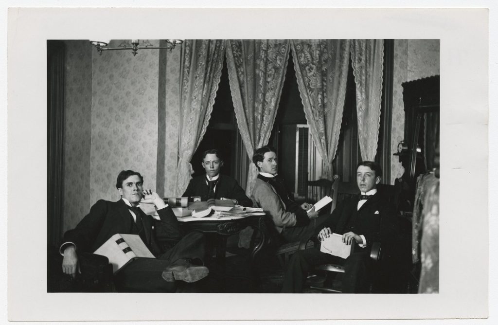 Photograph of four students reading, 1890s