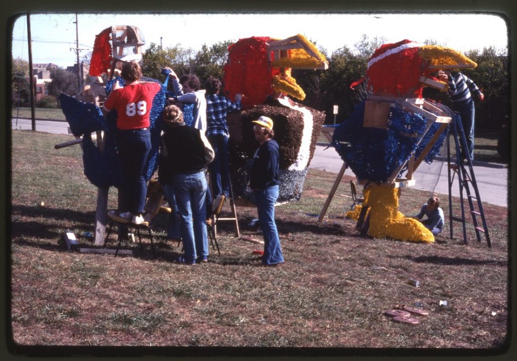 Photograph of KU students working on a Homecoming display, 1973