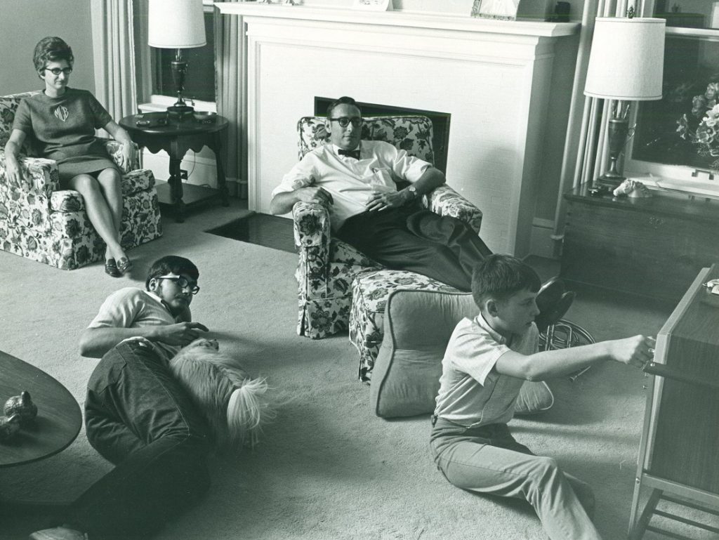 Photograph of Chancellor Laurence Chalmers watching television with his family, 1970