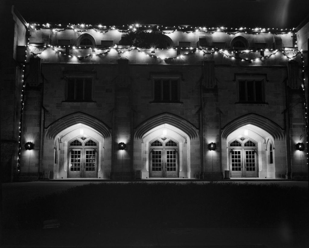 Photograph of Hoch Auditorium with holiday lights, 1954