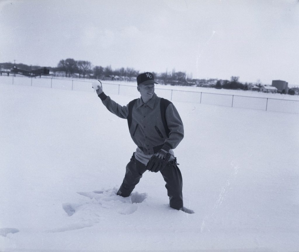 Photograph of a KU baseball player in the snow, 1950s