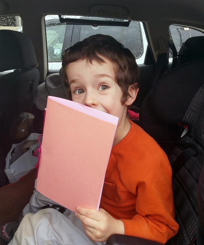 Child holding finished pamphlet