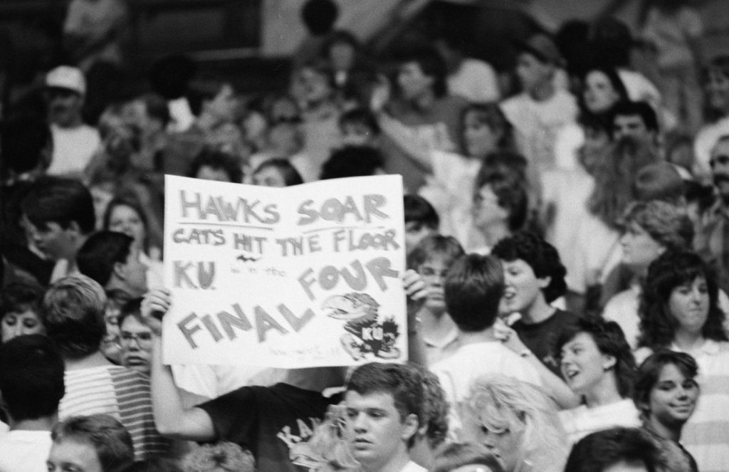 Photograph of KU basketball fans holding a sign, 1988