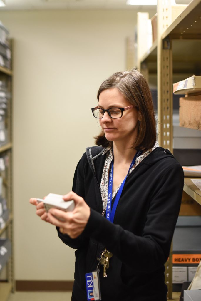 Staff member using a datalogger in the Spencer Library stacks, University of Kansas Libraries