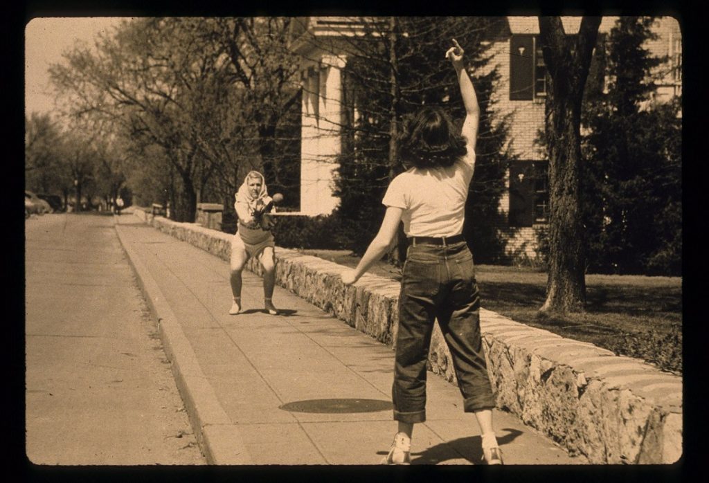 Photograph of two female students playing softball, 1940s