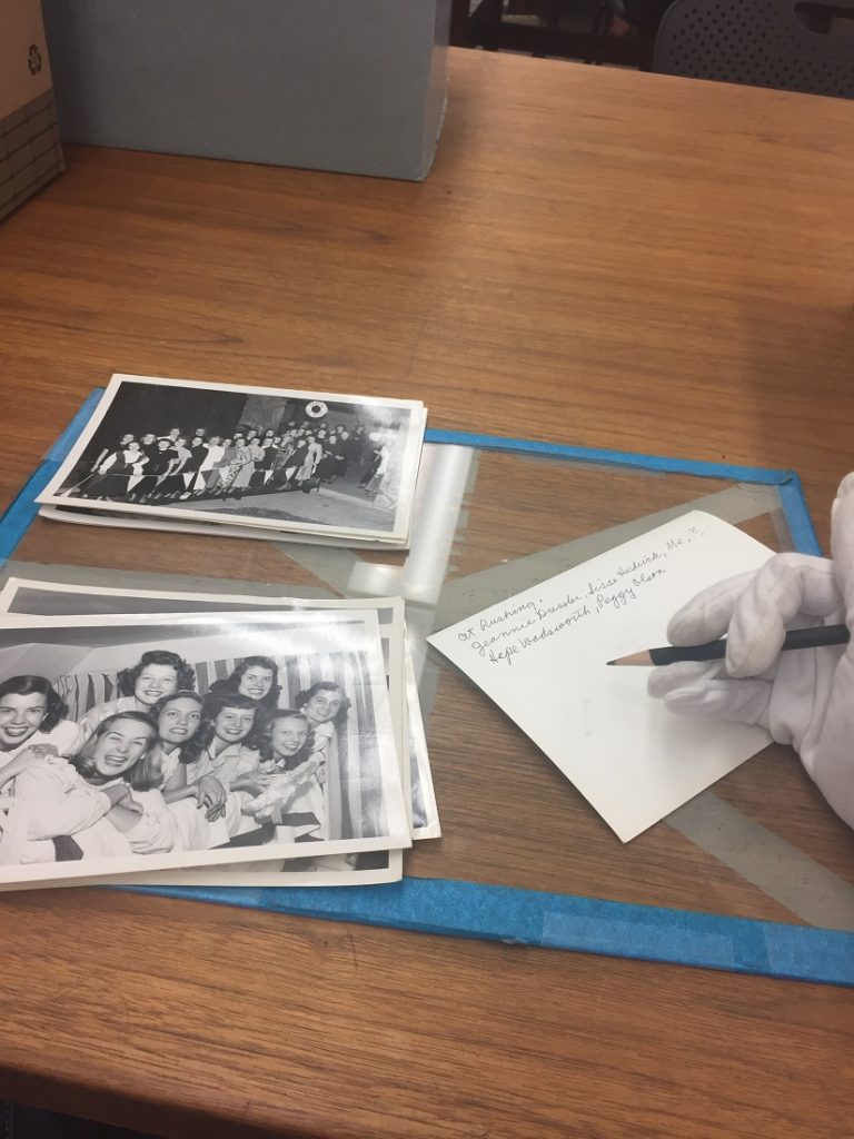 Photograph of Pi Beta Phi photographs being processed in University Archives