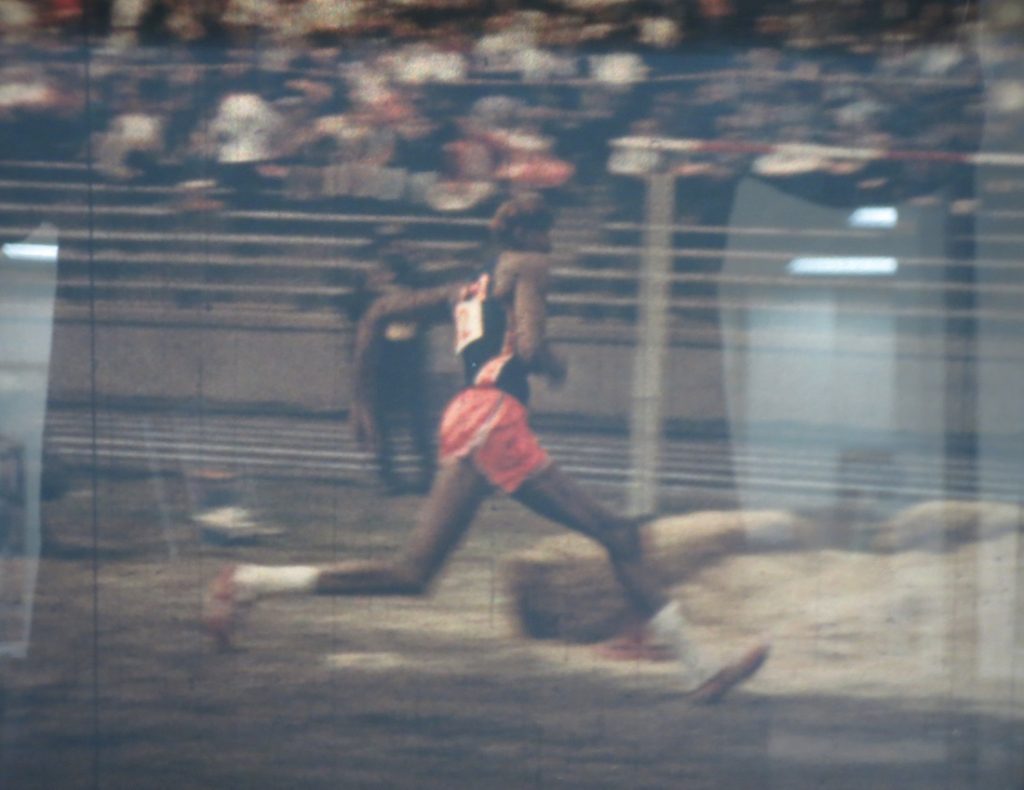 Film still of Wilt Chamberlain in the high jump event at the Kansas Relays, 1957