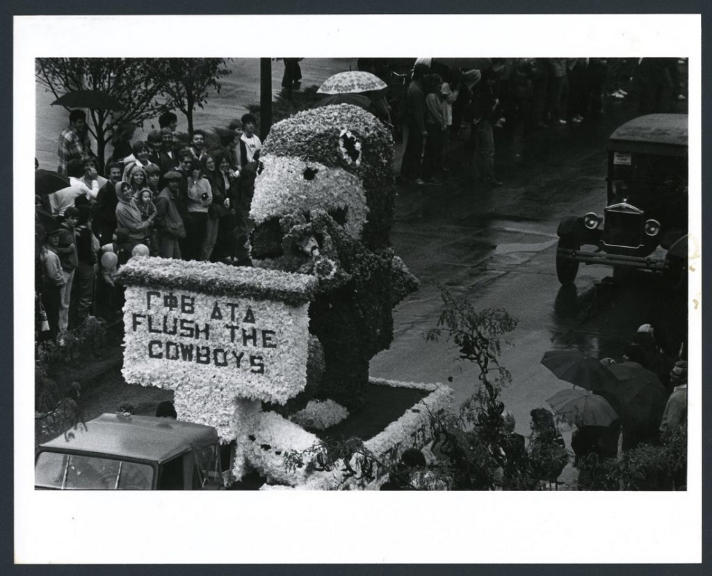 Photograph of the "Flush the Cowboys" float in the Homecoming parade, 1979