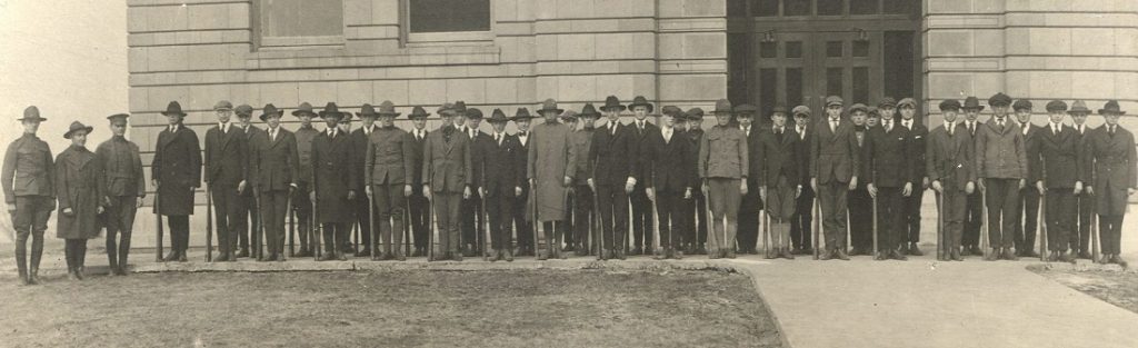 Photograph of members of KU's S.A.T.C. in front of Strong Hall, 1918