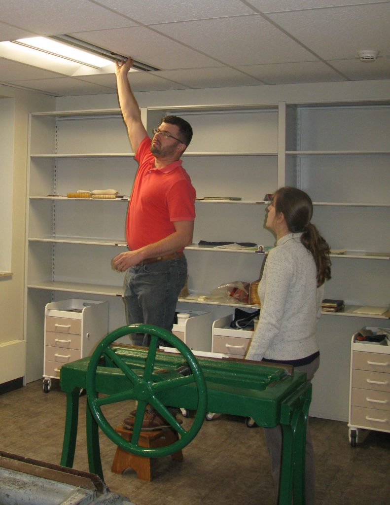 Consultants checking air flow in Spencer Research Library