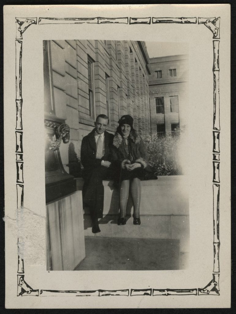 Photograph of two KU students sitting on the Strong Hall steps, 1925