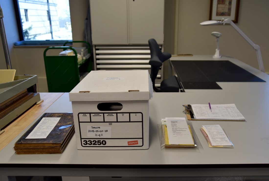 Items from Spencer Research Library awaiting treatment on the special collections conservator's bench.
