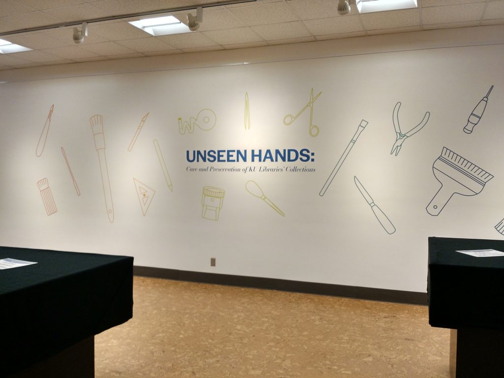 Wall graphic for "Unseen Hands" exhibit at Kenneth Spencer Research Library, University of Kansas Libraries.