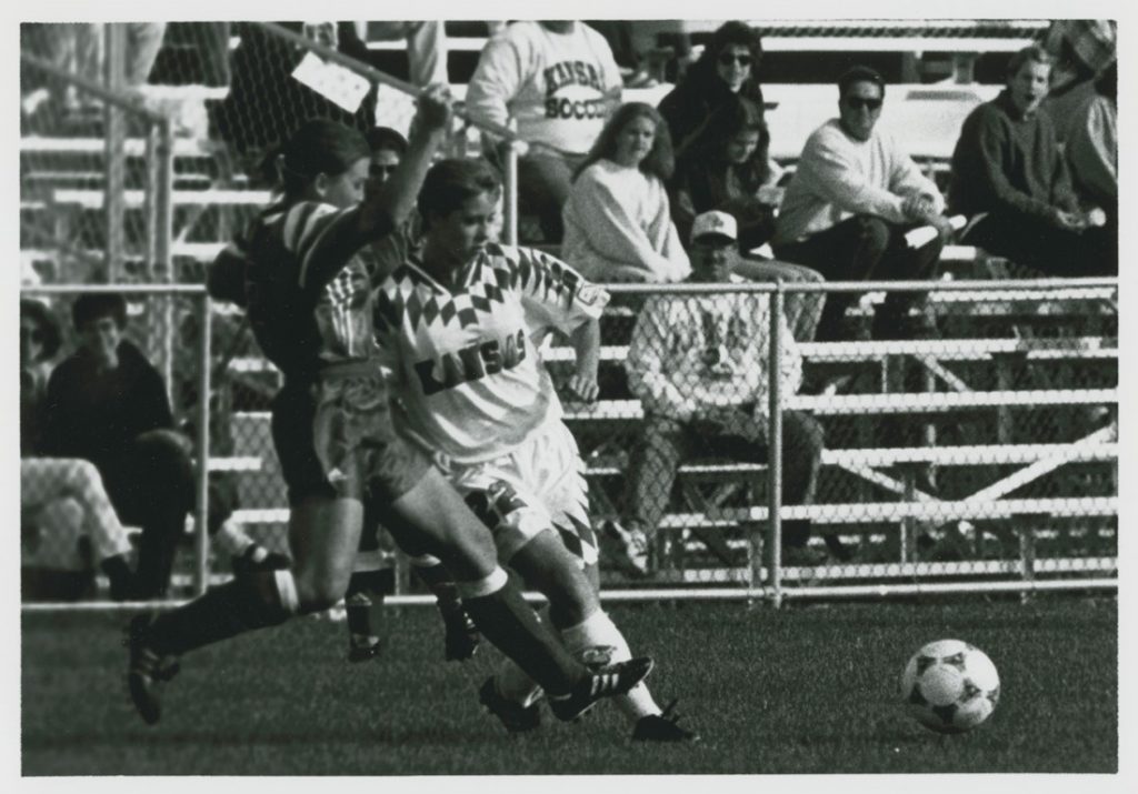 Photograph of two players fighting for the ball during a KU women's soccer game, 1995