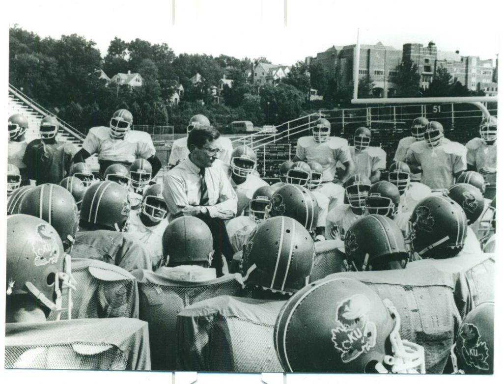 Photograph of Chancellor Gene Budig with the KU football team, 1980s