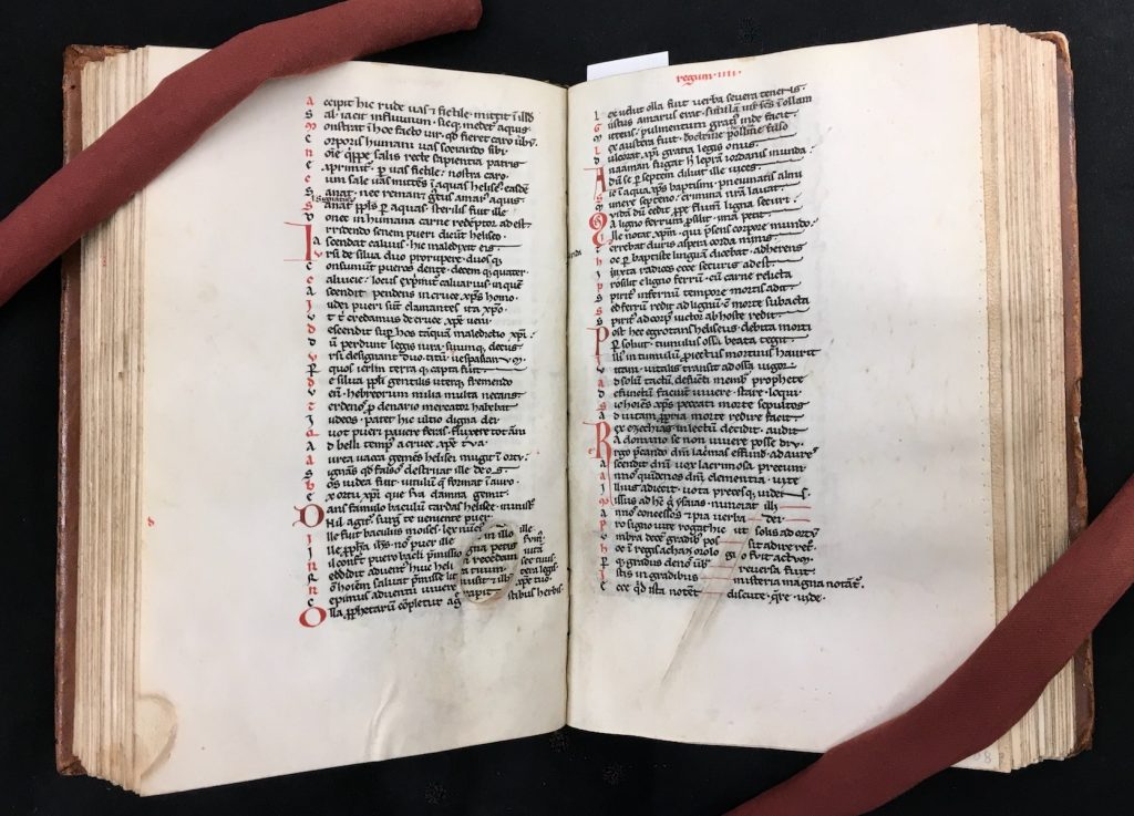 Holes and cuts visible on folios 107v and 108r of Spencer Library's copy of Petrus Riga, Aurora, Spain or southern France, first half of the thirteenth century. Call # MS C195.