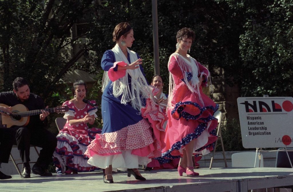 Photograph of two dancers at a music and dance performance sponsored by HALO in front of the Kansas Memorial Union, October 1997